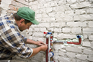 Mike is working on fixing a pipe leak